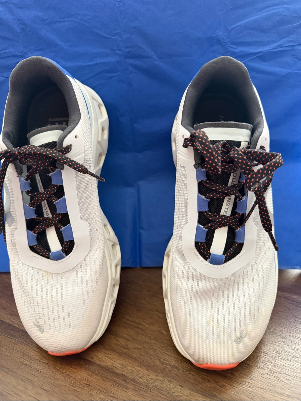 On Running Gray Sneakers with Blue Accents and Black/Orange Laces